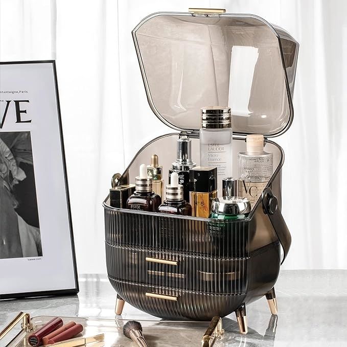 A sleek and open cosmetic organizer, filled with skincare and beauty products, displayed stylishly on a vanity with magazines and makeup brushes nearby.