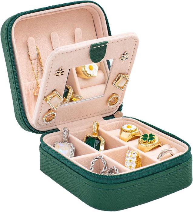 A green jewelry organizer displayed with all the jewelry neatly arranged inside