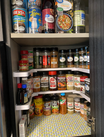 The same reviewer’s image showing a three-tier spice rack fitting perfectly within the kitchen cabinet, maximizing the available space