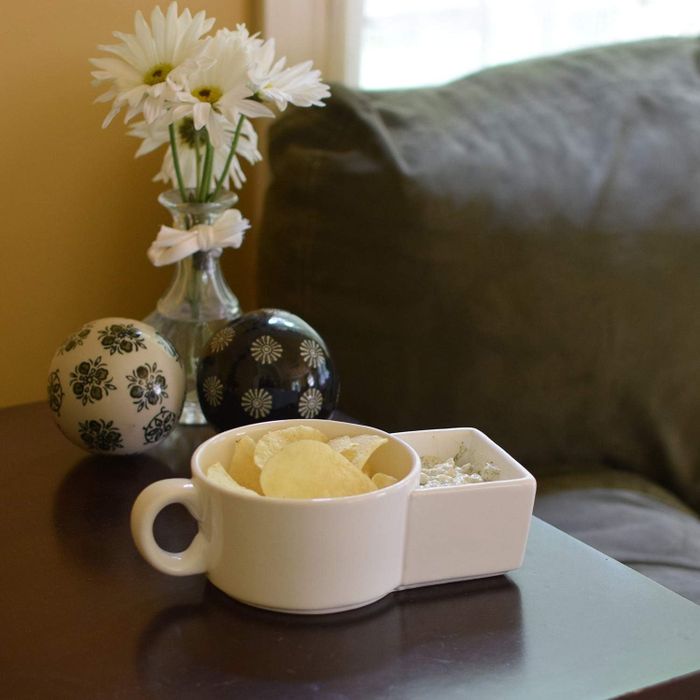 A sidecar-style mug filled with chips and dip.