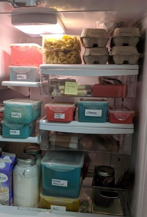 A reviewer displays their fridge, filled with neatly labeled items for better organization.