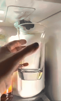 A person pressing the dispenser on a milk jug