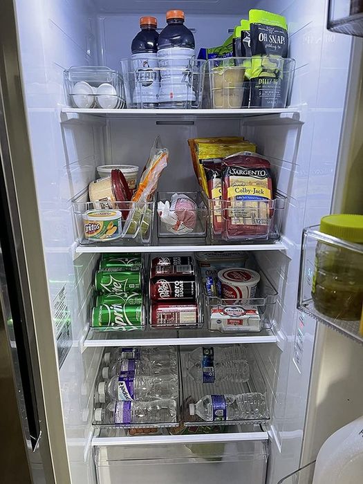 The reviewer shares a photo of a neatly arranged fridge using these storage containers