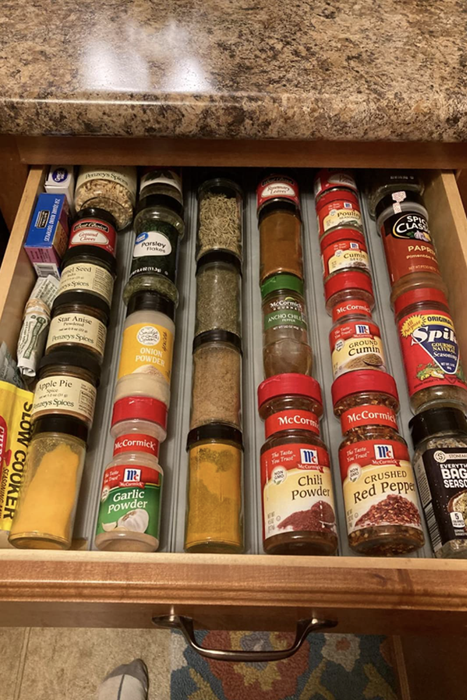 A reviewer’s after image showing the same drawer now organized with the spice rack drawer organizer