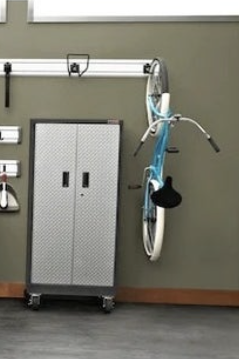 The hook displaying the bike hanging on a garage wall
