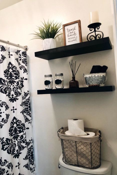 Another reviewer shows off two black shelves in their bathroom, demonstrating a stylish storage solution.