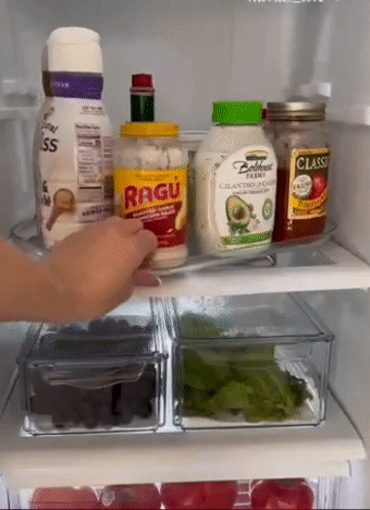 A model rotating the tray 360 degrees in a fridge to display all the condiments on it
