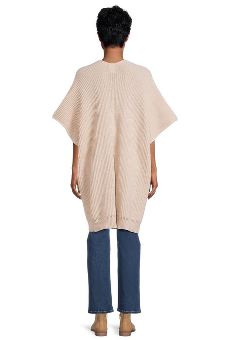 A back view of an individual in a long, loose-knit sweater and jeans, embodying a relaxed fit perfect for casual outings or a day of shopping.