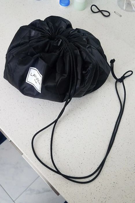 A reviewer's photo showing the cinched-up version of the makeup organizer.