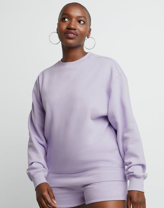 A model confidently strikes a pose in a casual lilac sweatshirt paired with matching shorts.