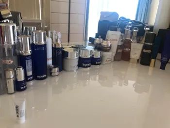 A reviewer’s dresser with an array of skincare products neatly lined up