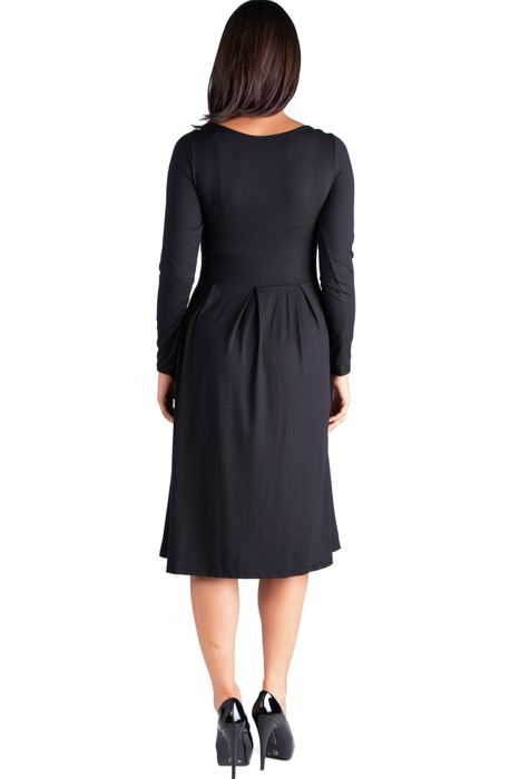 A person in a long-sleeve black dress with a pleated skirt and black heels, captured from the back, perfect for a fashion feature about shopping attire.