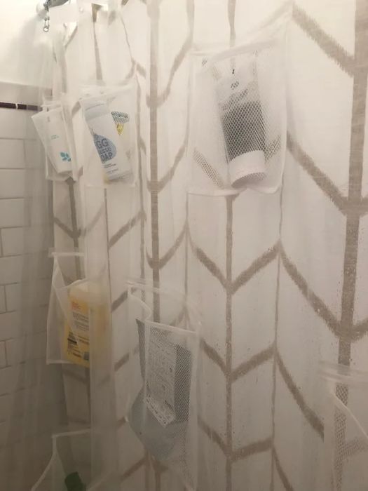 A transparent shower curtain liner featuring mesh pockets for your toiletries.