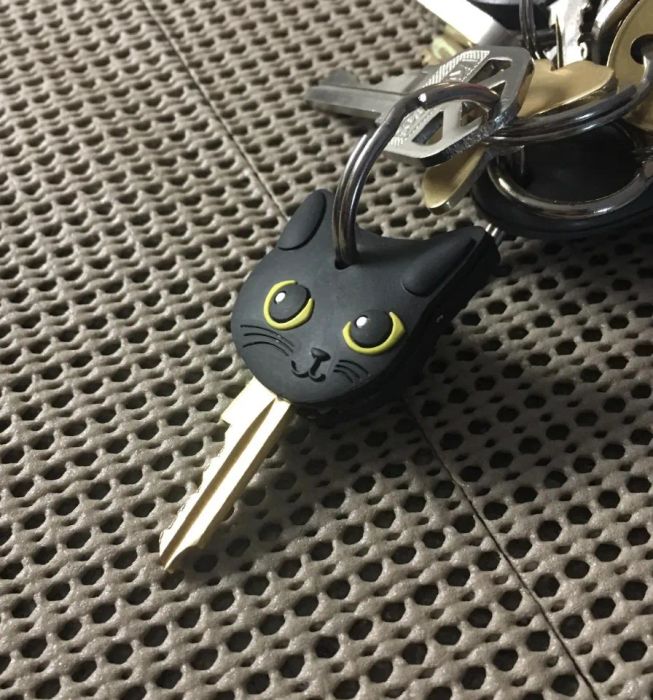 A black silicone cat charm attached to a keychain.