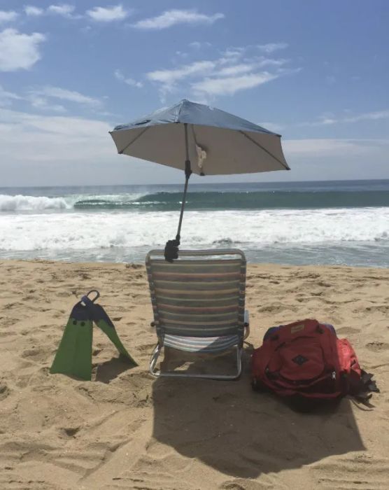 A Sportbrella attached to a beach chair.