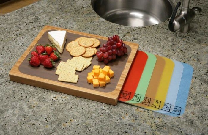 A cutting board with six vibrant, color-coded inserts placed within.