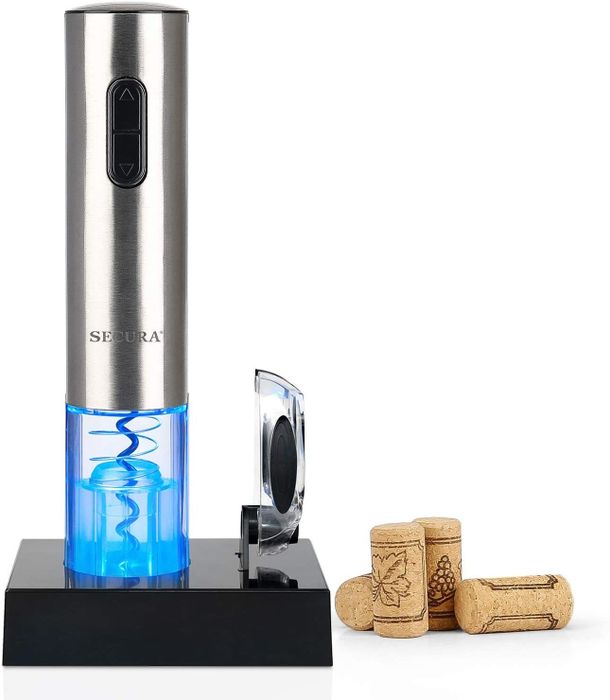 A wine bottle opener with corks next to it.