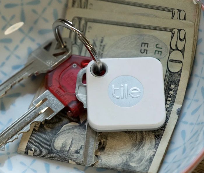 A white, square Tile Mate attached to a key ring.