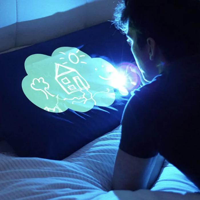 A person drawing on the pillowcase using a light pen.
