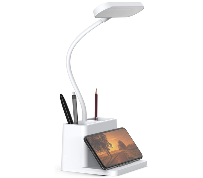 The desk lamp with a pen holder and phone rest in action.