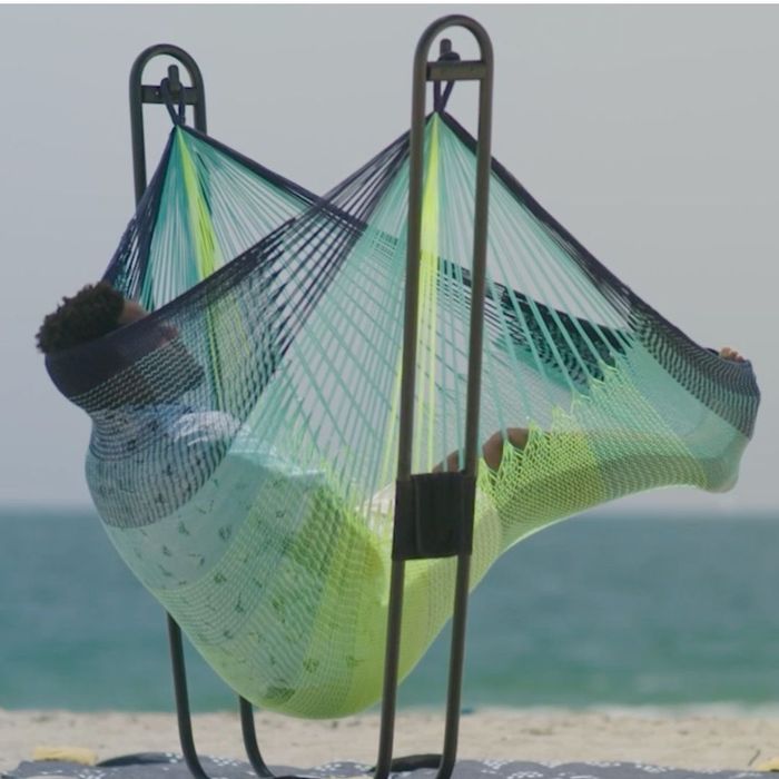 A person relaxing in the hammock chair