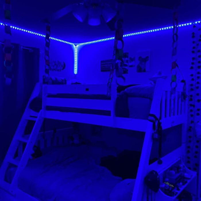The lights installed around the edges of a ceiling with the color set to blue.
