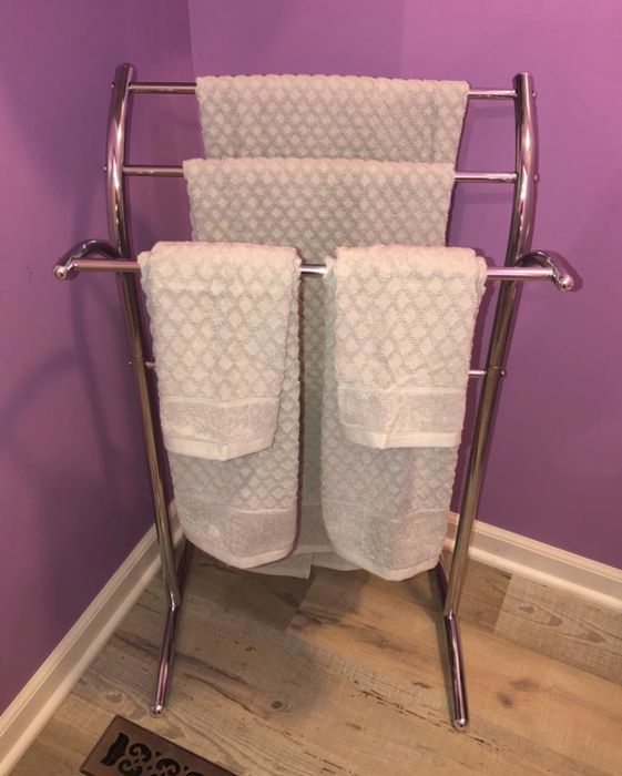 The towels placed in a bathroom with purple accents