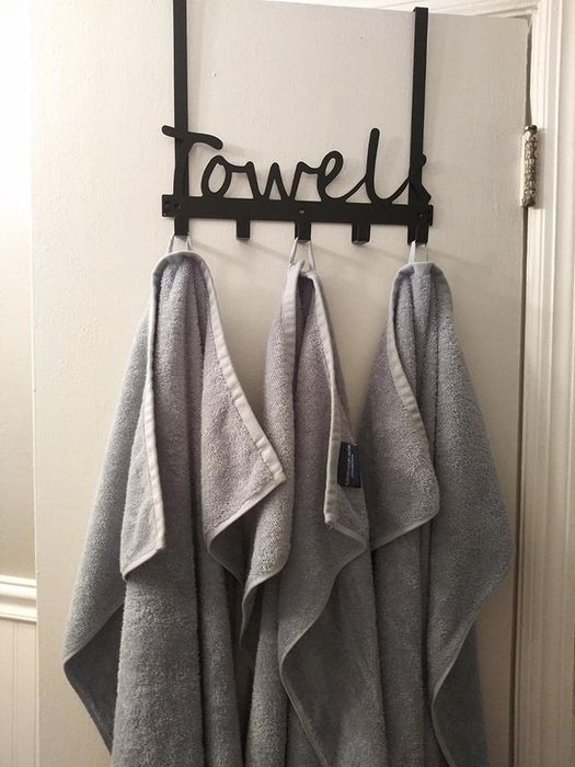 Three towels neatly hung on a hook labeled 'towel'