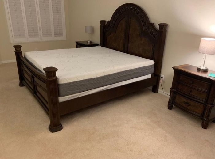 A king-sized mattress placed on a reviewer’s bed, with no sheets.