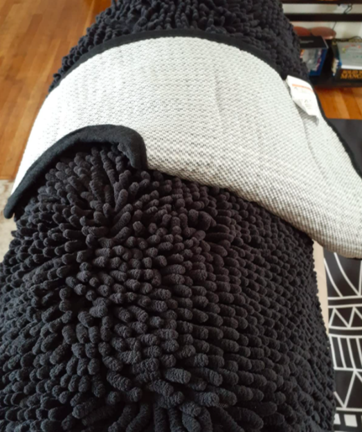 A reviewer’s photo of the rug showcasing its non-slip grip on the bottom.