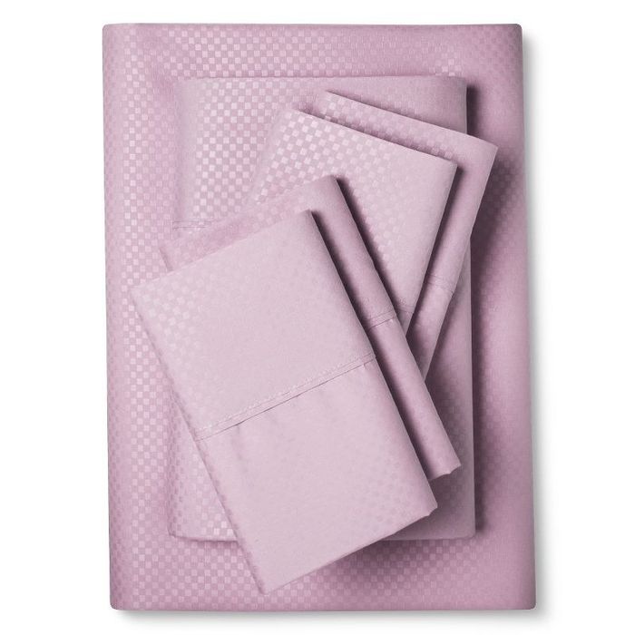A set of lilac checkered sheets, neatly folded.