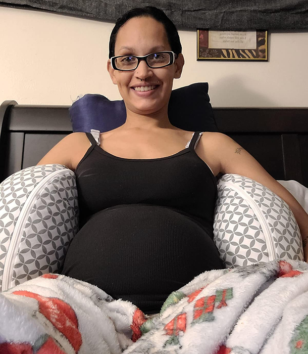 Reviewer lounging on the Boppy pregnancy pillow