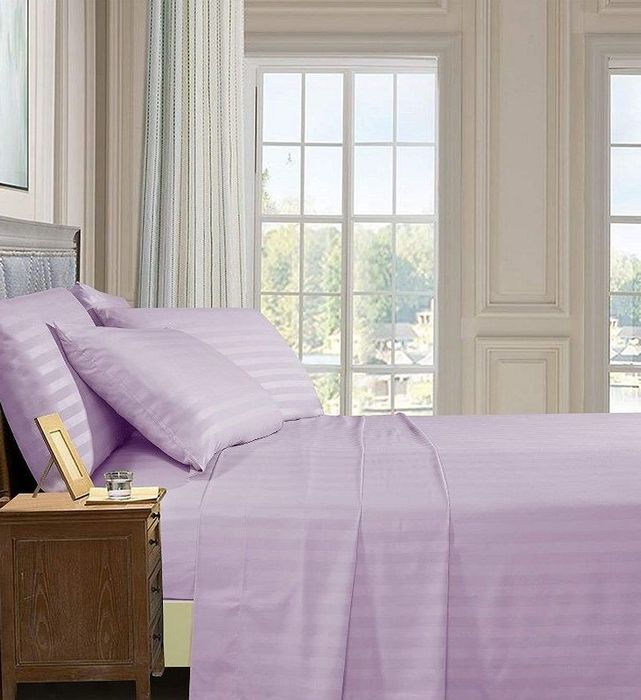 lilac-colored sheets on a bed