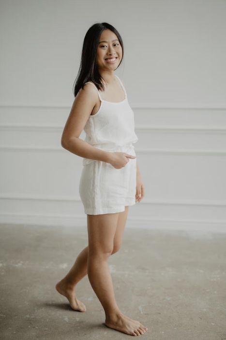A model wearing a spaghetti strap tank top and matching shorts