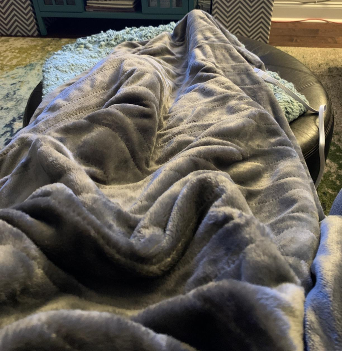 A reviewer image featuring a gray blanket