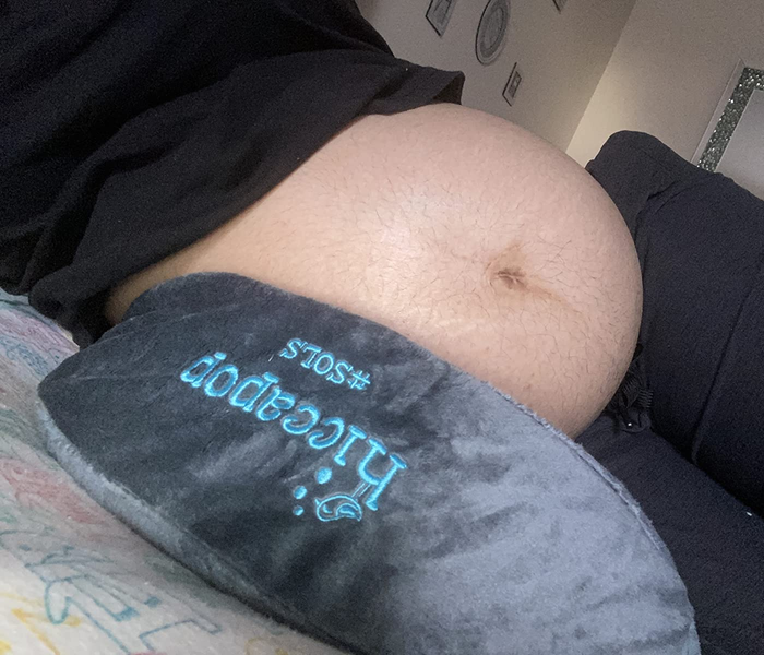 Reviewer lying on the gray wedge pillow