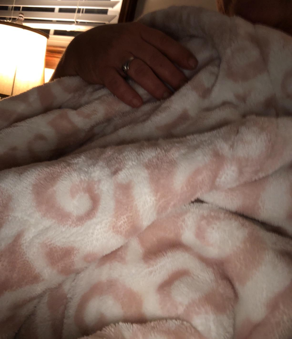 A reviewer image featuring a pink and white blanket