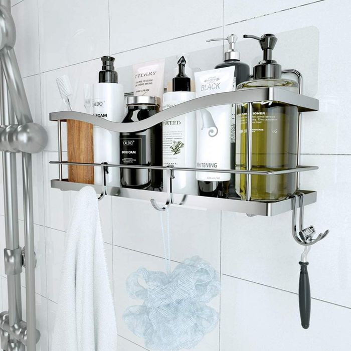 A silver shower caddy adorned with various products, mounted on the wall.