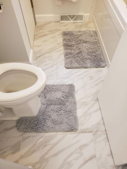 The gray mats placed in the bathroom.