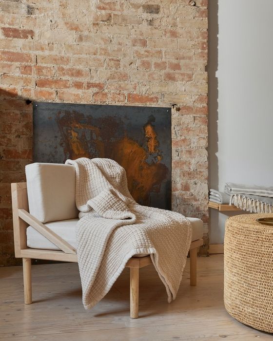 The quilt casually draped over an armchair