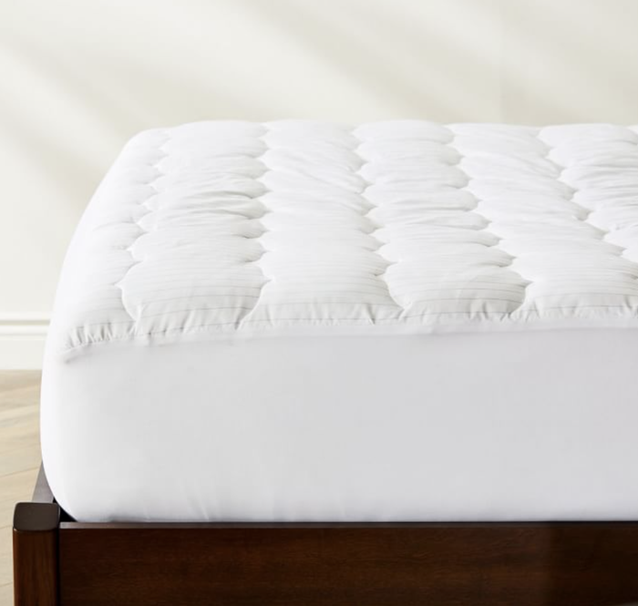 A side perspective of the white mattress topper.