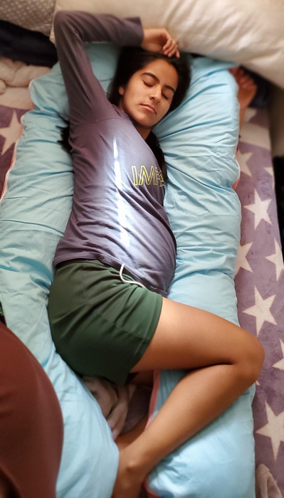 Reviewer lying on a light blue pillow, comfortably resting