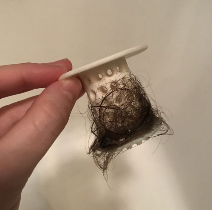 Mytour editor Jess Probus holding a TubShroom filled with hair.