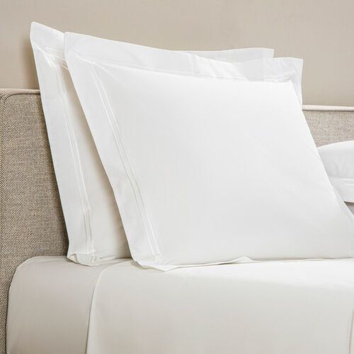 Two pillows adorned with crisp white shams.