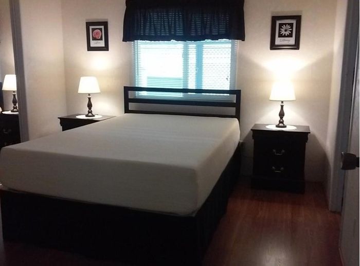 A full-sized mattress without sheets in a reviewer’s home, awaiting its first night of rest under the stars (or in this case, the sheets).
