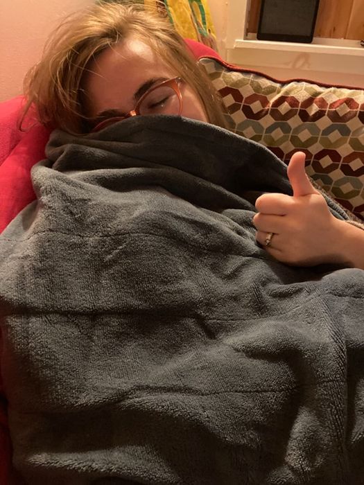 A reviewer image of someone wearing a gray blanket
