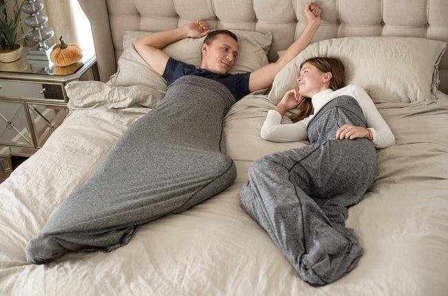 Two individuals enjoying the sleep pods while resting in bed