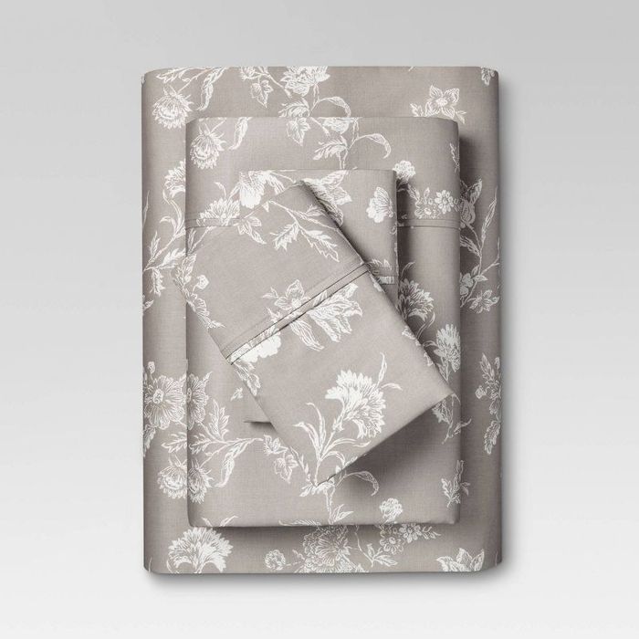 Grey and white floral-patterned sheets neatly folded.
