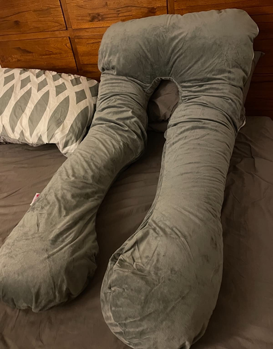 Reviewer photo of the gray U-shaped pregnancy pillow
