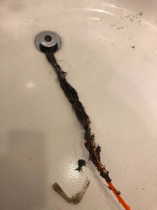 photo from a reviewer showing the drain snake removing debris from a drain